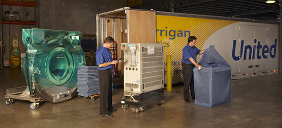 Corrigan Logistics warehouse workers packaging and loading items