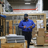 Inventory management employee inspecting items