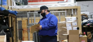 Worker inventorying product in warehouse